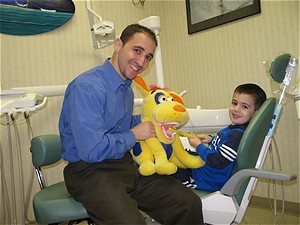 Emergency dentist treating young patient